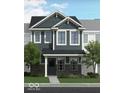 Charming two-story townhome with blue siding and stone accents with landscaped front yard at 19541 Grassy Branch Rd, Westfield, IN 46074