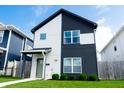 Attractive two-story home featuring a modern two-tone design and a lush green lawn at 2014 W Michigan St, Indianapolis, IN 46222