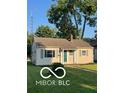 Inviting single-story home with well-manicured lawn, neutral siding, and inviting front door at 2028 Gilmore St, Columbus, IN 47201