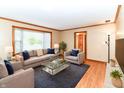 Cozy living room with plush seating, a glass coffee table, and plenty of natural light at 206 Banbury Rd, Noblesville, IN 46062