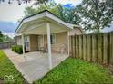 A covered porch adds curb appeal to this home featuring tidy landscaping and a wooden privacy fence at 3161 Normandy Rd, Indianapolis, IN 46222