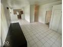 Open living room featuring neutral tile floors, and easy access to the kitchen at 3161 Normandy Rd, Indianapolis, IN 46222