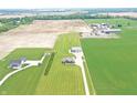 Expansive aerial view showcasing a home near large farm fields and buildings, surrounded by greenery at 3301 N 200 W, Franklin, IN 46131