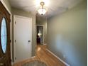 Inviting entryway features a decorative front door with glass insert, light-colored walls and durable laminate flooring at 386 Shadow Hill Dr, Greenwood, IN 46142