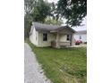 Quaint home featuring a cozy front porch and adjacent gravel driveway at 4521 Vernon Ave, Indianapolis, IN 46226