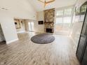 Bright living room boasts stone fireplace, ceiling fan, and large windows for lots of natural light at 4635 Stansbury Ct, Indianapolis, IN 46254