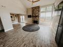 Bright living room with stone fireplace, wood ceiling fan, and high ceilings at 4635 Stansbury Ct, Indianapolis, IN 46254
