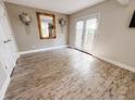 Bright room featuring beautiful hardwood floors, wall sconces, and a large mirror at 4635 Stansbury Ct, Indianapolis, IN 46254