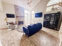 Bright living room featuring a stone fireplace, vaulted ceilings, and modern furnishings at 4635 Stansbury Ct, Indianapolis, IN 46254