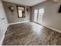 Living room featuring hard wood floors, mirror and sconces at 4635 Stansbury Ct, Indianapolis, IN 46254
