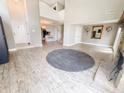 Open living room with high ceilings, gray rug, and hardwood floors at 4635 Stansbury Ct, Indianapolis, IN 46254