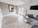 Bright room features a large mirror, stylish armchair, and walkout access at 4635 Stansbury Ct, Indianapolis, IN 46254