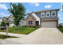 Attractive home with a combination of brick and gray siding, complemented by a well-maintained lawn at 4832 W Safford Dr, New Palestine, IN 46163