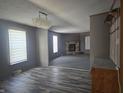 Inviting living room featuring a stone fireplace and attractive wood-look flooring at 496 Tague St, Greenfield, IN 46140