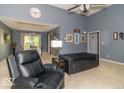 Bright and open living room featuring high ceilings and easy access to the dining area at 5104 W Prairiewood Dr, Muncie, IN 47304