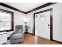 Cozy living room featuring hardwood floors, a gray recliner and abundant natural light at 5203 Carrollton Ave, Indianapolis, IN 46220