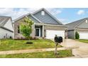 Well-maintained one-story home featuring a gray brick facade, a 2-car garage and lovely landscaping at 5439 Maywood Dr, Whitestown, IN 46075
