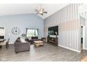 Bright living room with vaulted ceiling, neutral walls, laminate flooring, a large window and modern decor at 5439 Maywood Dr, Whitestown, IN 46075
