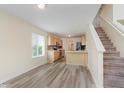 Bright dining area with stairs, kitchen, modern flooring, and natural light at 565 Cembra Dr, Greenwood, IN 46143