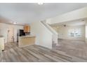 Bright living room area with stairs, dining area, modern flooring, and natural light at 565 Cembra Dr, Greenwood, IN 46143