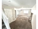 Spacious living room featuring neutral carpet, fireplace, and plenty of natural light at 5826 Buck Rill Dr, Indianapolis, IN 46237