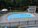 Inviting in-ground pool with surrounding patio, garden, and shed for relaxing summer days and evenings at 6220 E 56Th St, Indianapolis, IN 46226
