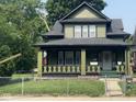 Charming two-story home featuring a covered front porch and a well-maintained yard at 624 N Rural St, Indianapolis, IN 46201