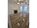 Spacious living room with a decorative fireplace, hardwood floors, and bright, white walls at 6368 Titania Dr, Indianapolis, IN 46236