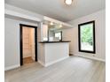 Open-concept living room featuring stylish flooring and a serving hatch into the kitchen at 706 University Blvd, Anderson, IN 46012