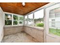 Enclosed porch with multiple windows offering views of the surrounding neighborhood at 706 University Blvd, Anderson, IN 46012