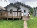 Exterior view of home featuring a wooden deck and access stairs from the backyard at 730 N Riley Ave, Indianapolis, IN 46201
