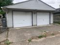 Detached two car garage featuring white doors and concrete driveway at 730 N Riley Ave, Indianapolis, IN 46201