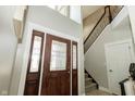 Grand foyer featuring a dark wood door and staircase at 750 Trillium St, Lebanon, IN 46052