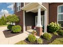 A close-up of the front porch with well-maintained landscaping at 750 Trillium St, Lebanon, IN 46052