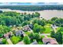 Gorgeous aerial view of waterfront property with boat docks in a lakeside neighborhood with mature trees at 826 N Lanyard Dr, Cicero, IN 46034