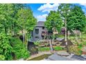 View of the tiered backyard with terraced retaining walls, stairs to the lake and docks below at 826 N Lanyard Dr, Cicero, IN 46034