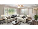 Bright living room with a large window, comfortable seating, and neutral decor at 9378 N County Road 75 W, Lizton, IN 46149