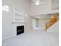 Spacious living room with a cozy fireplace, built-in shelves, and natural light at 9406 Avon Strand # Apt A, Avon, IN 46123