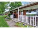 Covered porch with white railing, ideal for relaxing outdoors at 9974 N 850 W, Fairland, IN 46126