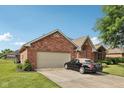 Red brick home with two-car garage and well-manicured lawn at 1027 Plum St # 39, Brownsburg, IN 46112