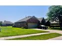Attractive brick home with attached garage, well-maintained landscaping and paved driveway at 1027 Plum St # 39, Brownsburg, IN 46112