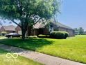 Beautiful brick house with lush green lawn and mature tree in a desirable neighborhood at 1027 Plum St # 39, Brownsburg, IN 46112