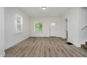 Bright living room features white walls, wood-look flooring, and abundant natural light from multiple windows at 1038 W 33Rd St, Indianapolis, IN 46208