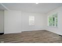 Neutral living space with wood-look floors, white walls, and natural lighting at 1038 W 33Rd St, Indianapolis, IN 46208