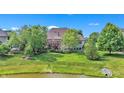 Spacious backyard overlooking a pond and lush trees at 10471 Winghaven Dr, Noblesville, IN 46060