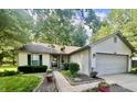Well-manicured front yard with attractive landscaping and a concrete driveway at 108 Meadowview Dr, Mooresville, IN 46158