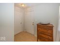 Bright entryway featuring hardwood floors and a stylish wooden dresser at 11830 Sand Creek Blvd, Fishers, IN 46037
