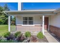Inviting front porch with white railings, brick accents, and verdant landscaping at 11830 Sand Creek Blvd, Fishers, IN 46037
