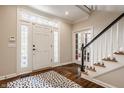 Inviting foyer with hardwood floors, staircase, and decorative rug at 1229 Helford Ln, Carmel, IN 46032