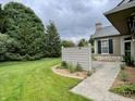 The home features a well-maintained backyard with lush green grass and mature trees at 125 Bridgemor Ln, Mooresville, IN 46158